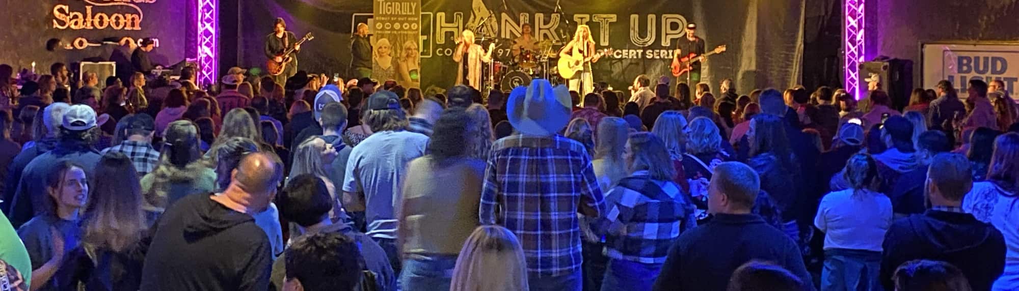 country concert with fans wearing cowboy hats Eugene